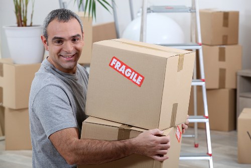 Moving team using PPE and floor protection in a property