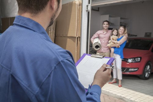 Driver and helper preparing for a move in Enfield with boxes and furniture