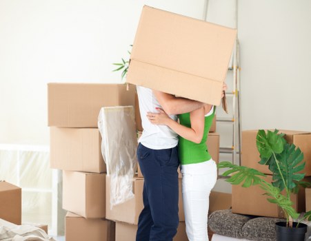 Careful transport of a piano through a residential property in Enfield