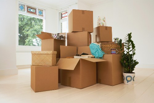 Removal staff handling household items with care during loading